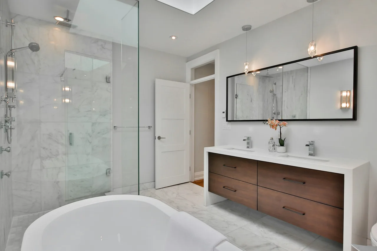 AI bathroom design preview showing a walnut floating double-sink vanity with quartz counter and chrome fixtures.