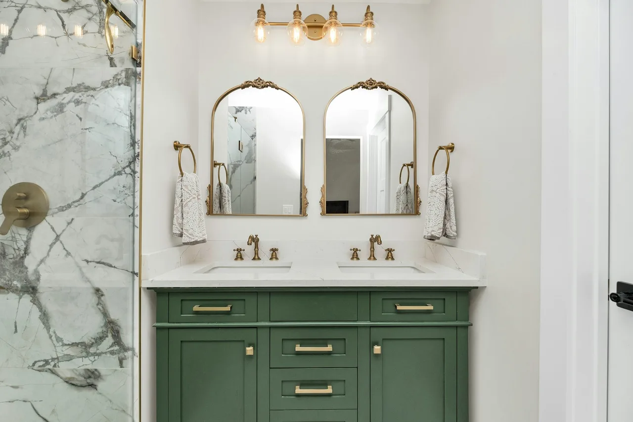 Editorial AI bathroom render with green shaker vanity, brass fixtures, and marble shower for contractor reference.