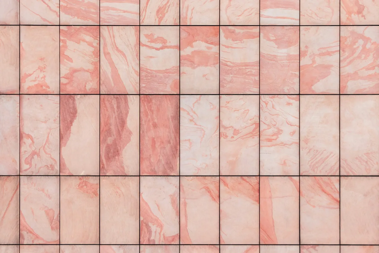 Close-up of pink marble tile pattern showing veining and grout layout for AI bathroom tile preview.